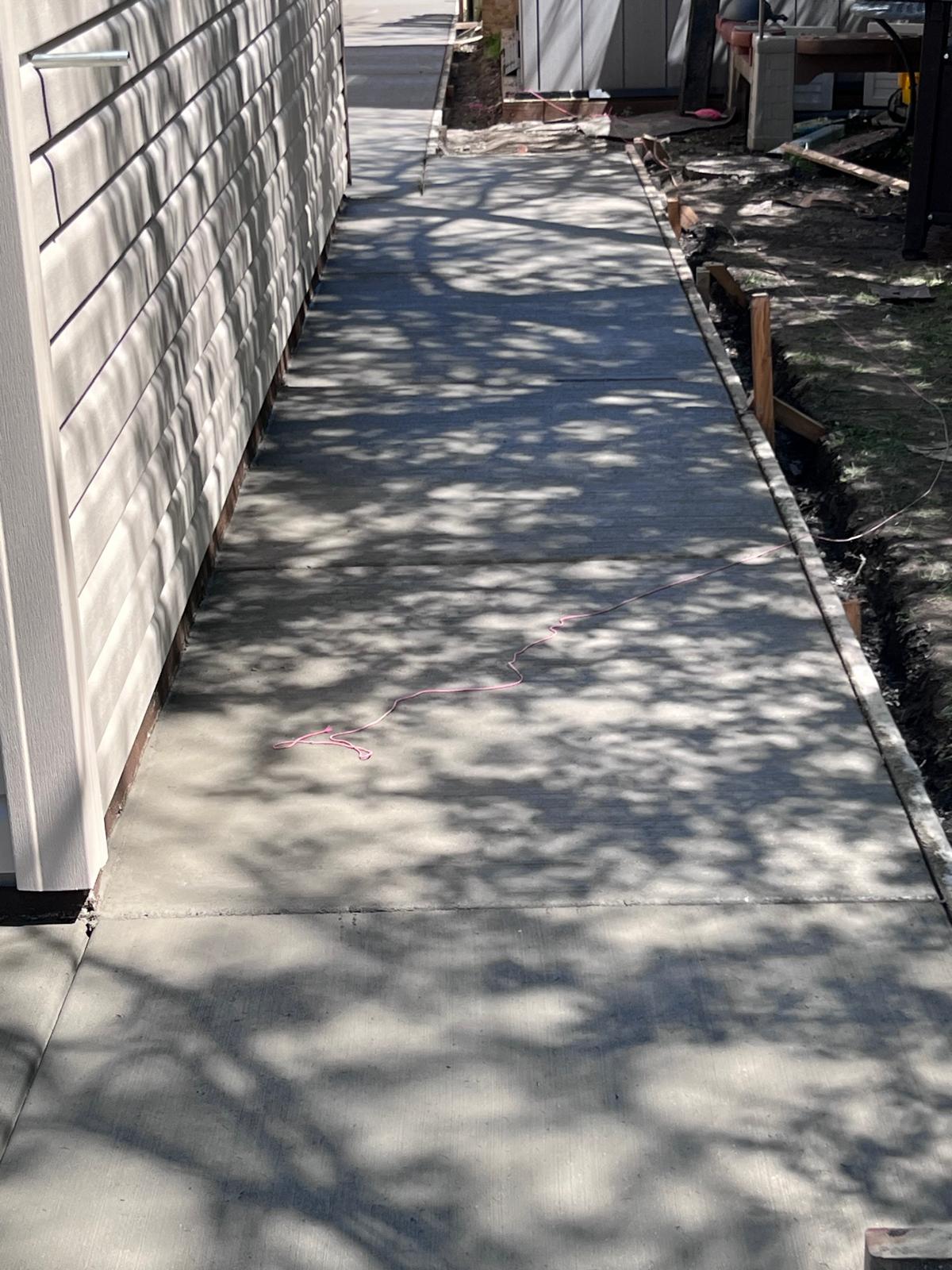 Finished concrete sidewalk along a home