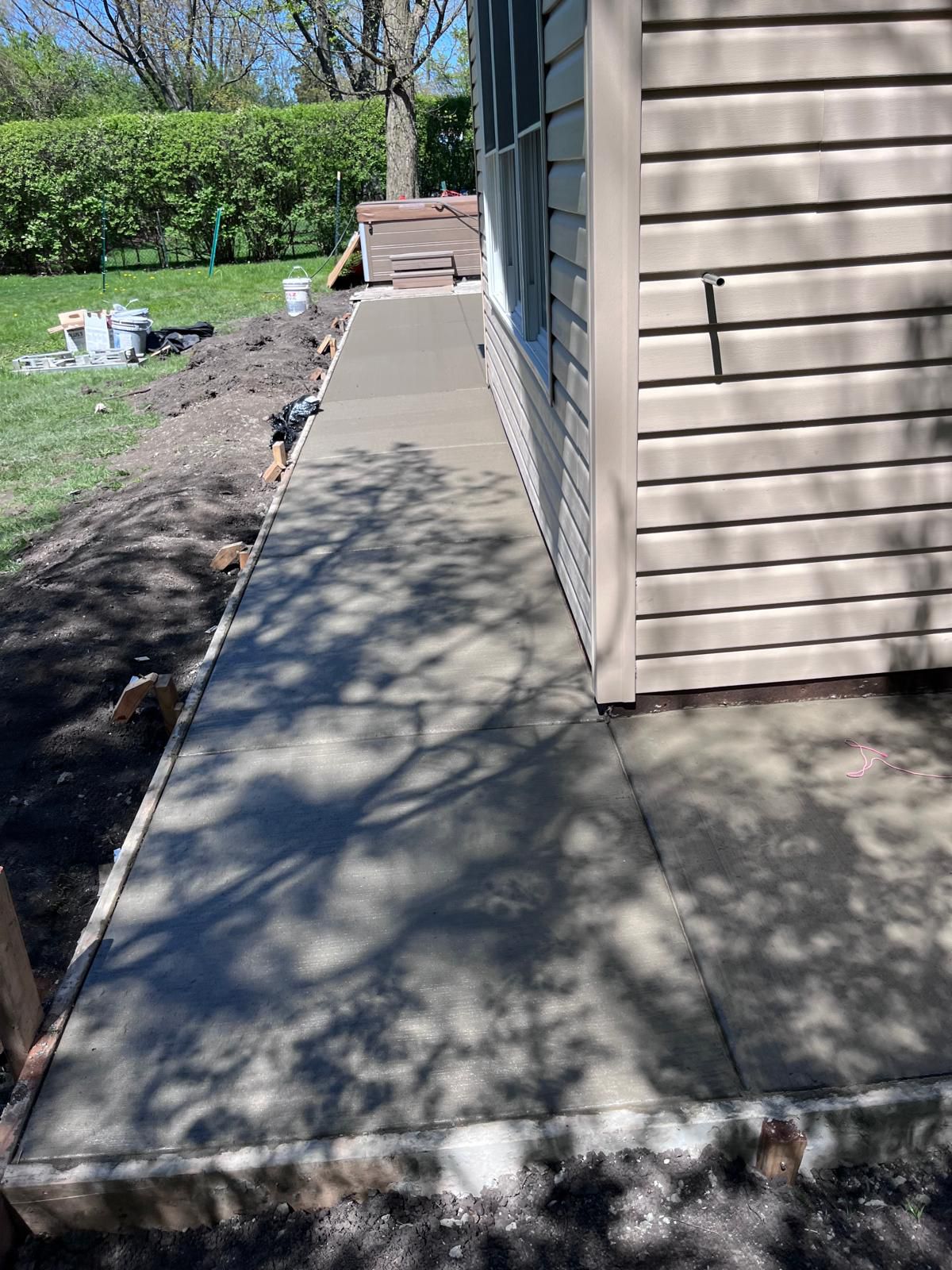 Finished concrete sidewalk along a side yard