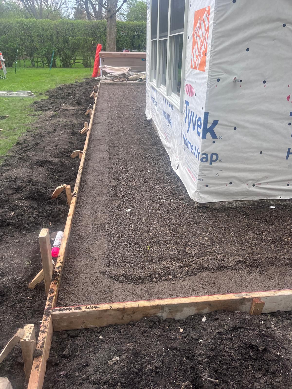 Prepared sidewalk base with wood forms